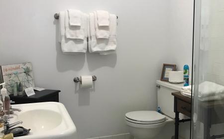Bathroom with walk in shower and pedestal sink