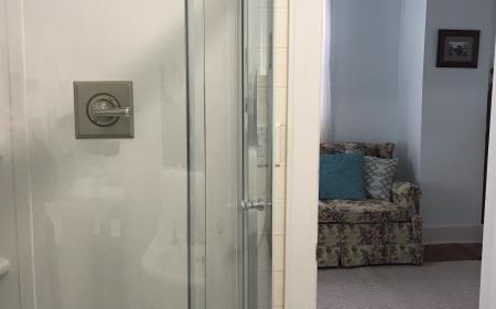 Shows walk in shower and doorway into sitting area